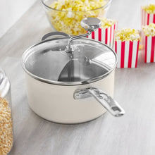 Cream stainless steel popcorn popper with glass lid and stirring rod handle
