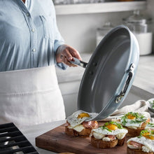 GreenPan The Big Fry pan tilted to show its gray nonstick interior and metal helper handle