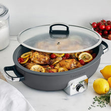 Graphite electric ceramic nonstick oval skillet with lid over roasted chicken and vegetables