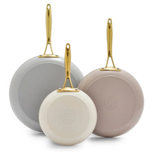Cream skillet set of three with gold handles: large, medium, and small pans