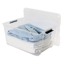 Clear storage bin with latching lid holding folded blue towels