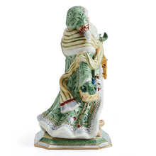 Santa figurine rear angle in green cloak with striped trim and lantern in hand