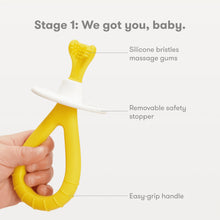 Yellow silicone bristle training toothbrush with removable safety stopper and easy-grip handle