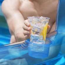 Inflatable pool cup holder with transparent drink cup in yellow liquid