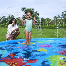 Kids splashing in an undersea splash pad with vivid sea-creature artwork