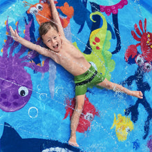 Undersea splash pad with colorful fish graphics, splashing child in the pool