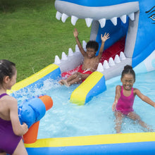 Kids inflatable water park with blue-and-white whale mouth slide and splash pool