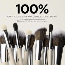 Makeup brush set with mixed brush heads, black and beige handles, and silver ferrules