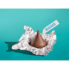 Milk chocolate candy in crinkled silver foil with one cone centered