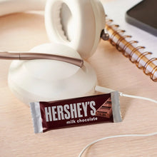 HERSHEY'S milk chocolate bar in foil wrapper with broken chocolate pieces