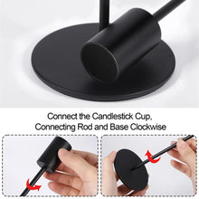 Black metal taper candle holder with round base and matte cylindrical cup