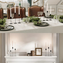 Black metal taper candle holders with slim rods and round weighted bases