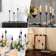 Black metal taper candle holders with slim rods, round bases, and candle cups