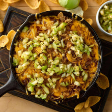Skillet of chili with chopped green onions on top