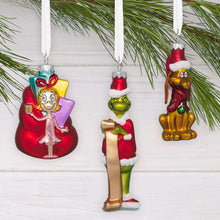 Four glass ornaments with colorful elf figures, green faces, red coats, Santa hats