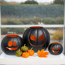 Black metal pumpkin lantern set of 3 with orange jack-o-lantern faces and orange tops