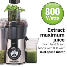 Juice extractor with control knob, clear pulp container, and green juice cup
