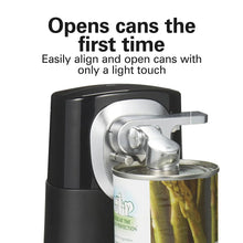 Black can opener holding a can with chrome cutting mechanism overhead
