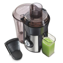 Juice extractor with clear pulp container, black filter basket, and juice cup