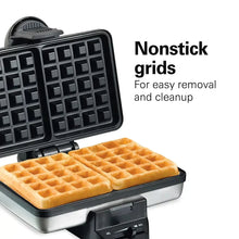 Belgian waffle maker showing black nonstick waffle grids with baked golden waffles