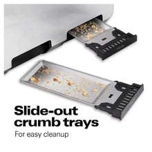 Slide-out crumb trays open with scattered crumbs and black eject racks