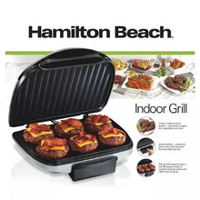 Indoor electric grill on retail packaging, closed lid with black grill plate