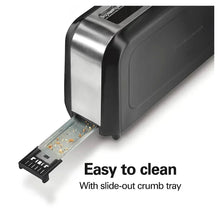 Long-slot toaster with slide-out crumb tray pulled out, showing crumbs