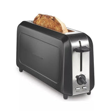Long-slot toaster with bread in slot and control panel with dials