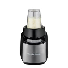 Hamilton Beach blender base with clear blending jar filled with light powder