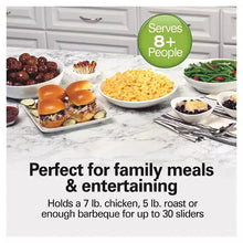 Hamilton Beach 7-quart programmable slow cooker on table with prepared dishes