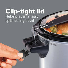 Clip-tight slow cooker lid with latch mechanism shown being held by a hand
