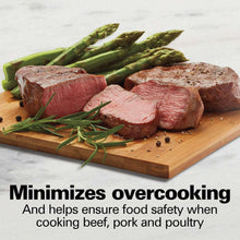 Raw beef steaks on a wooden board with asparagus and herbs