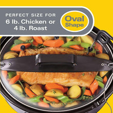Oval slow cooker interior with chicken and mixed vegetables visible through lid