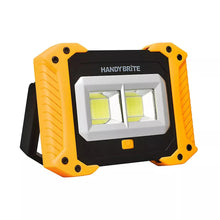 Orange cordless work light with dual LED panels and black handle