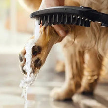 Handheld dog showerhead spraying water onto a dog coat