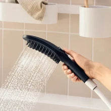 Handheld dog showerhead with black face and multiple spray nozzles