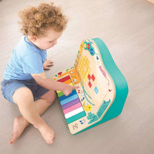 Pixel piano arcade toy with teal frame and multicolor keys, shown from above