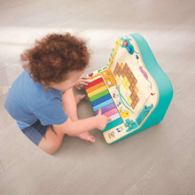 Teal pixel piano arcade toy with colorful key row and blue interactive grid