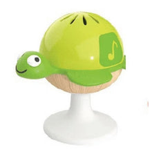Green turtle stay-put rattle with smiling face, wood base, and suction stand