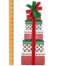 Vertical tower of wrapped holiday boxes with red ribbon, green bow, tree and stripe pattern