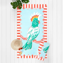 Beach towel with light blue bird illustration and coral-and-white striped border