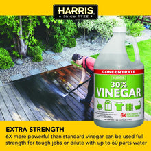 Harris 30% concentrated vinegar bottle beside person scrubbing deck, red-green label