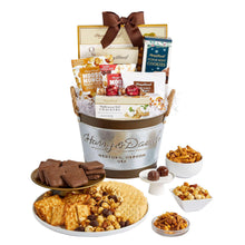 Gift basket with ribbon bow; assorted cookies, crackers, and chocolate snacks