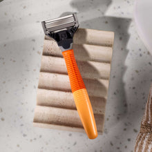 Orange handled 5-blade shaving razor with black cartridge head