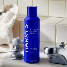 Harry's foaming shave gel bottle with blue cap on bathroom sink counter