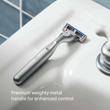 Metal safety razor handle with 5-blade cartridge head, close-up