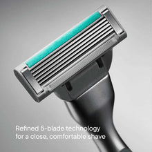 Close-up of 5-blade razor cartridge with teal strip on metal head