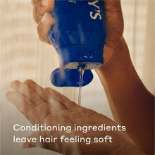 Harry's 2-in-1 shampoo & conditioner bottle pouring into hand, blue Aspen