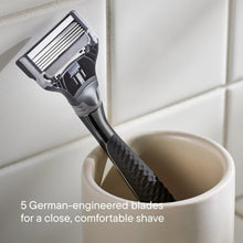 Men's razor with close-up blade head and textured black handle grip