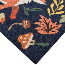 Hooked accent rug corner with navy texture and orange, green, and cream leaf pattern